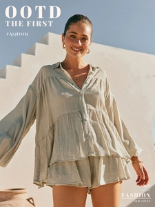 Close-up of ruffled hem and crinkle texture fabric on a sage green casual shirt set