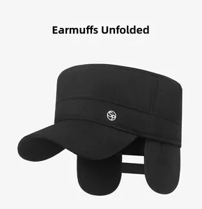 Close-up of winter flat top cap featuring deployed ear flaps and a silver SP metal logo