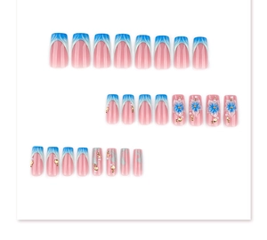 Detail of French blue ombre press-on nails featuring 3D floral accents and pearls