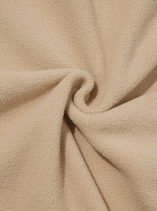 Detailed macro view of soft apricot polar fleece fabric showing thick texture and pile