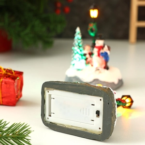 Detail of battery compartment and manual power switch on the light-up Christmas figurine