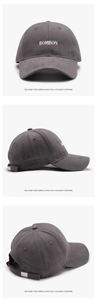 Three views of a dark grey cotton baseball cap featuring BOMBON letter embroidery