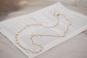 Detail of baroque pearl necklace with gold chain and adjustable lobster clasp closure