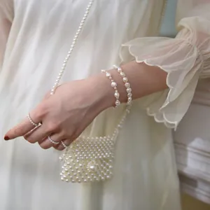 Detail of baroque pearl bracelet and matching rings with vintage french style finish