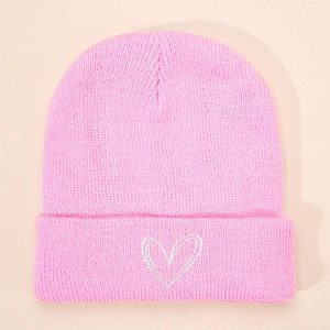 Close-up of fine knit pink beanie featuring a white embroidered heart on the cuff