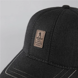 Close-up of wool texture and leather embossed patch on men's winter baseball cap
