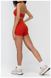 Rear view of red sports set showing breathable mesh back bra and tight yoga shorts