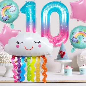 Detailed setup of rainbow tassel cloud and number 10 foil balloons for 10th birthday party