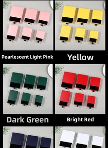 Various sizes of drawer jewelry boxes in pink, yellow, red and green with black foam inserts