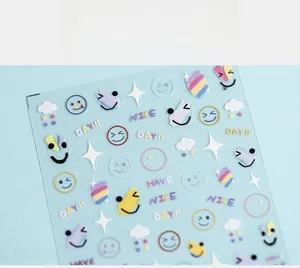Close-up of 5D cute nail art stickers with rainbow smiley faces and stars