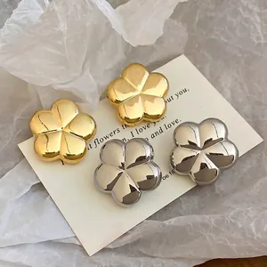 Minimalist metallic five-petal flower stud earrings in polished gold and silver finishes