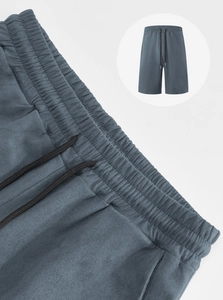 Detail of grey-blue men's sports shorts with adjustable drawstring elastic waistband