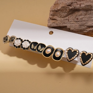 Vintage gold hair clip set with black enamel flowers, butterflies and pearl details