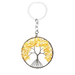 Natural yellow crystal tree of life keychain with silver wire wrap on white background