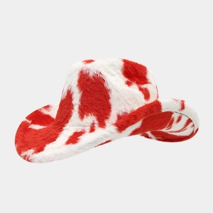 Detailed close-up of plush red and white cow print texture on a western cowboy hat