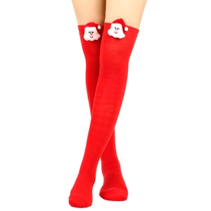 Detail view of red Christmas over-knee socks with a 3D Santa Claus plush decorative head