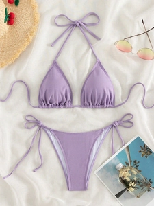 Detailed view of lavender purple waffle textured bikini with adjustable side ties and halter top