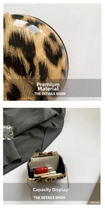 Detailed view of leopard print clutch capacity showing space for phone and lipsticks