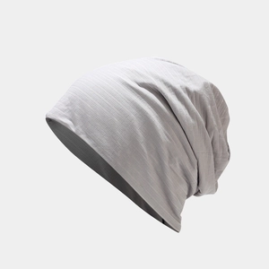 Close-up of light gray thin double-layer beanie with fine vertical rib texture