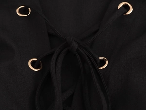 Close-up detail of French style dress with metal eyelets and black lace-up ties