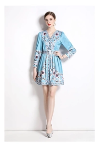 Detail of V-neck floral mini dress with light blue fabric and decorative geometric lace