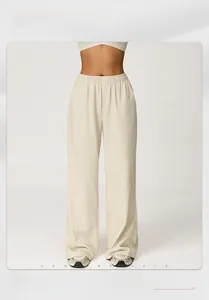 Detail of high-waisted wide-leg joggers featuring elastic waistband and drape fabric