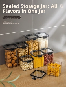 Detail of airtight transparent food storage jars with black locking lids on wood table