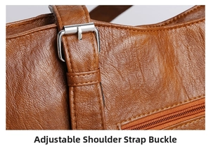 Close-up of adjustable silver buckle and lychee texture on brown leather bag