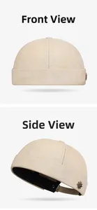 Detail view of beige docker cap with metallic leaf emblem and premium cotton twill stitching