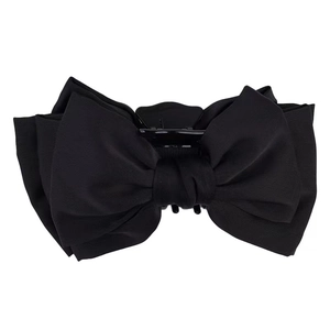 Elegant large black bow hair claw clip made of fine fabric for bun and half-up hairstyles