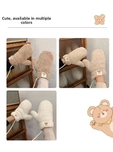 Close-up of winter fleece mittens with bear patch, lanyard and soft plush texture