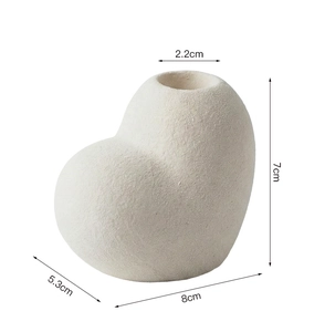 Close-up of heart-shaped white ceramic vase with 2.2cm opening and matte texture