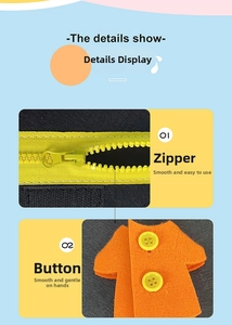 Detail view of toddler busy board showing functional yellow zipper and button fastening