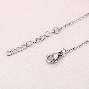 Detail of silver stainless steel lobster clasp and extender chain on smiley face bracelet