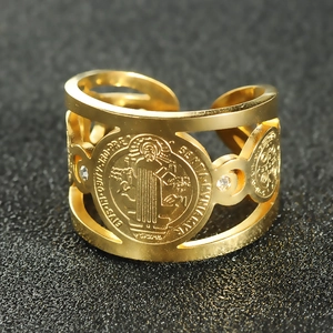 Detail of gold Saint Benedict medal ring with white diamonds and adjustable open band
