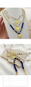 Detail of bohemian beaded necklace with 18k gold monstera leaf pendant and 43cm chain