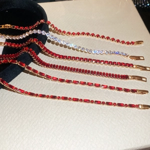 Detail of 18k gold tennis bracelets with red rubies and white round diamonds