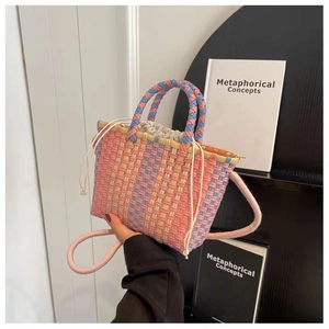 Detail of colorful woven basket bag with drawstring liner and knotted rope handles