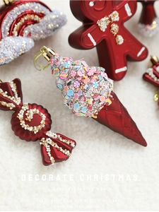 Close-up of burgundy Christmas ornaments with glitter details on white faux fur background