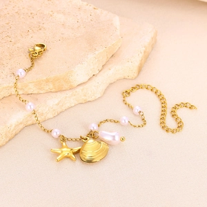 Detail of golden starfish and shell charms with pink pearls on a stainless steel chain