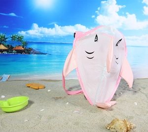 Pink shark mesh beach bag for kids with adjustable strap on sunny beach sand