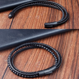 Detail of multi-layer braided leather bracelet with black beads and magnetic metal clasp
