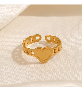 Detail of adjustable gold-tone heart ring with chain design on silk fabric