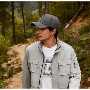 Detail of warm grey winter baseball cap with ear flaps and wool texture on a model