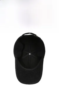 Detail of warm black wool winter cap with soft fleece lining and foldable ear flaps