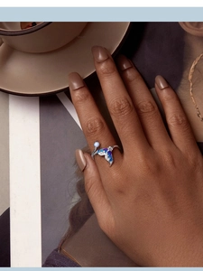 Detailed view of 925 sterling silver mermaid tail ring with blue enamel and opal gem