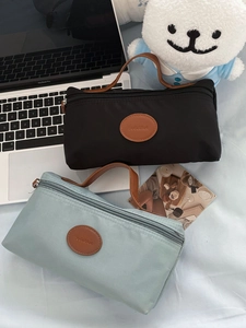 Waterproof nylon cosmetic travel bags in black and blue with leather handles and logo