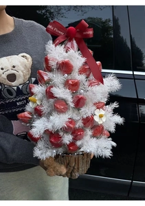 Detail of Christmas strawberry tree gift box with pearl accents and wooden base