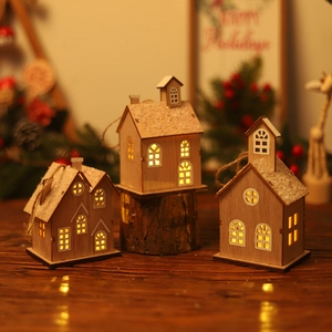 Three-piece set of wooden Christmas LED glowing cabins with snow roofs and warm lights