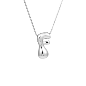 Detail of silver puffy letter F pendant with polished finish on a box chain necklace